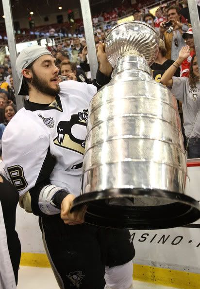 Kris Letang on ice with the cup.