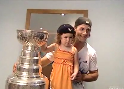 Kris Letang with kid and cup.